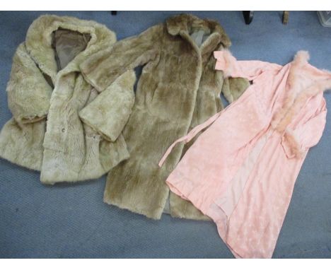 Two vintage fur coats, together with a mid 20th century coral coloured robe with feather trim. Condition - one fur coat A/F w