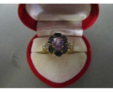 A 10ct gold sapphire, diamond and amethyst set cluster ring 