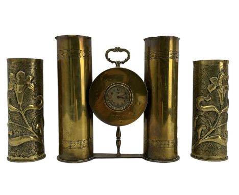 World War I Trench Art clock formed from two brass shell cases H28cm and a pair of Trench Art vases with a raised pattern of 