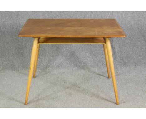 An Ercol light elm side table, with an undertier on beech supports. H.74 W.98 D.68cm. 
