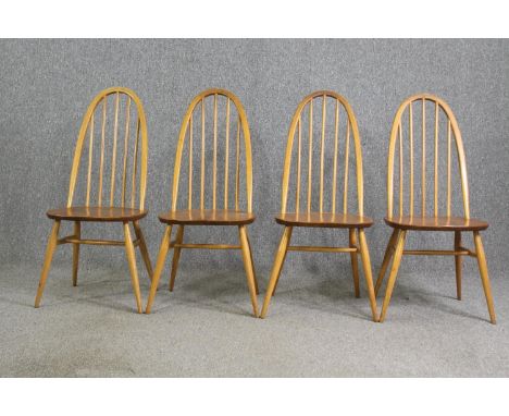 A set of four Ercol beech and light elm dining chairs. 