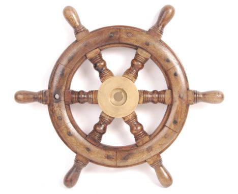 A late 19th / early 20th century oak and brass ship / boat steering wheel having a central heavy brass mount with turned wood