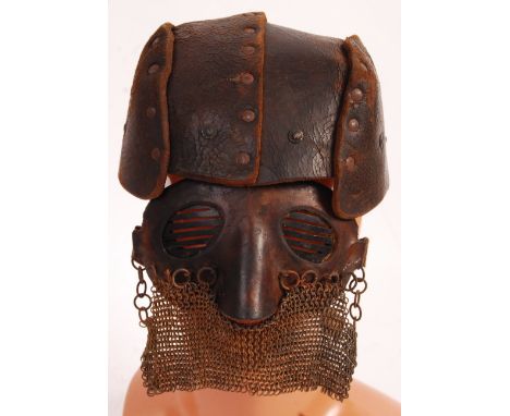 An incredible believed original WWI First World War era Tank Corp driver's ' splatter ' mask and accompanying leather helmet.
