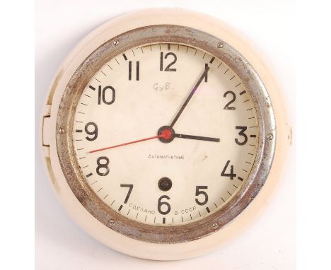 A vintage post-WWII Second World War Russian submarine bulkhead clock. Russian text to dial, with hinged opening front. Perio