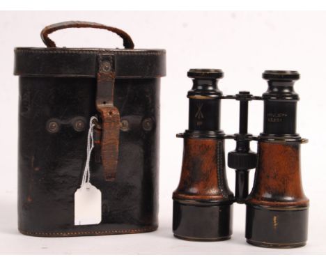A pair of WWI First World War military issue field binoculars. The binoculars with crows' foot military markings, and engrave