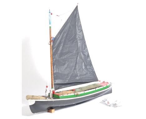 A 20th century large scale scratch built model of a sailing boat / ship. Painted details with sails, sacks etc.. Top section 