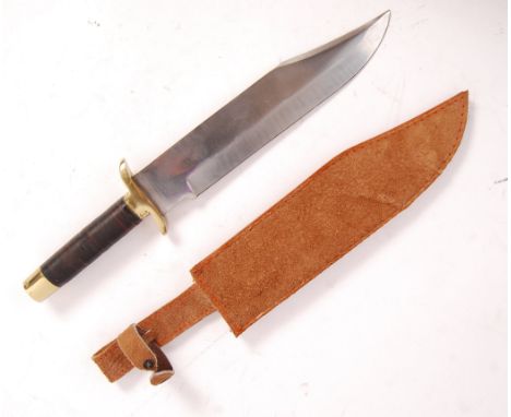 A late 20th century traditional Bowie knife having disk horn grip with brass pommel and recurve crossguard with a large fixed