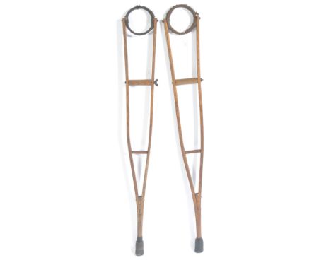 A pair of original WWI First World War era British hospital use oak and elm wooden medical crutches having a multi positional