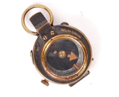 A WWI First World War British Military Verner's Pattern VII prismatic compass having a a brass body hinged lid with glass win
