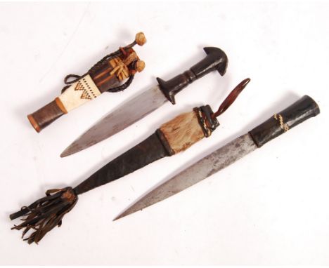 Two early 20th century African arm daggers to include; Sudanese Mahdi Dervish Arm Dagger with leather clad shaped hilt, doubl