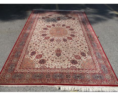 A Tehran machine made carpet with a central medallion and palmets on a cream ground, 122" x 79" 