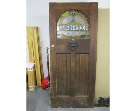 A late 19th/early 20th century Edwardian oak and stained glass front door in the Art Nouveau style with cast iron letter box/