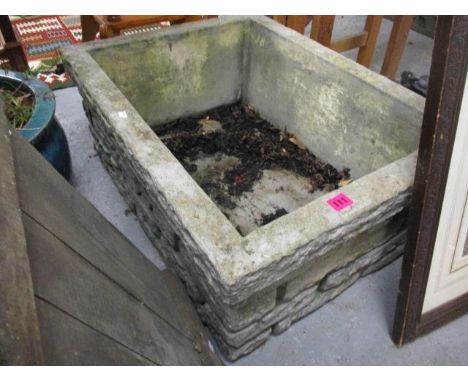 A composition stone garden trough, 11"h x 28"w 