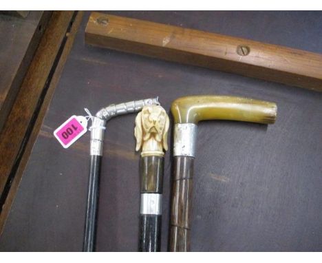 A selection of two silver topped walking sticks, together with a composition topped walking stick in the form of a dogs head 