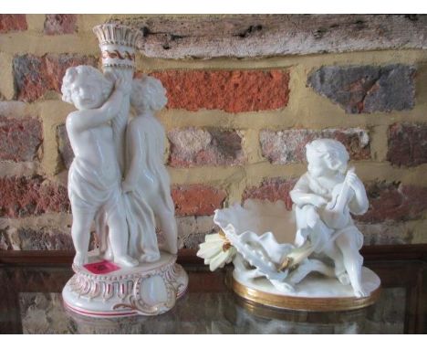 An early 20th century Copeland candlestick flanked by putti, together with an early 20th century Moore porcelain dish in the 
