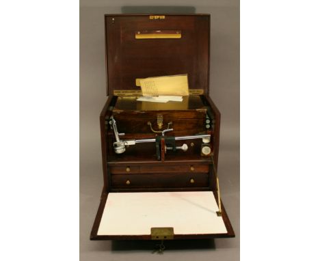 A MAHOGANY FISHERMAN'S FLY TYING CHEST having a hinged top and facia, a removable box, three drawers and a bench fly tying vi