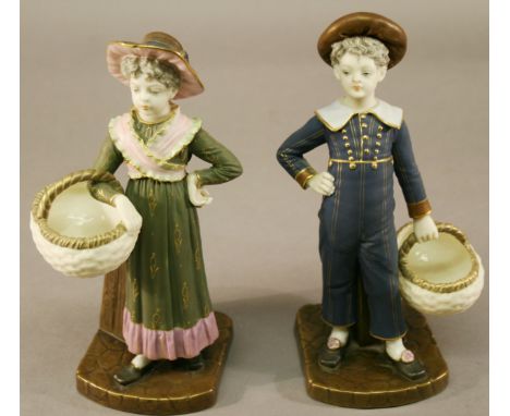 A PAIR OF VICTORIAN ROYAL WORCESTER FIGURES of a boy and girl in period attire holding baskets, date code 1882. 22cm(h) CONDI