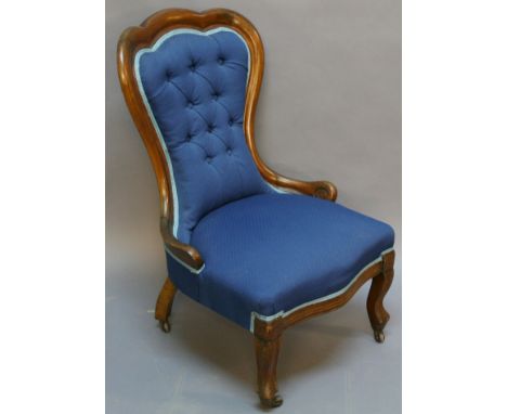 A VICTORIAN MAHOGANY NURSING CHAIR having a lobed top-rail, deep-buttoned back and sprung serpentine-fronted seat, raised on 