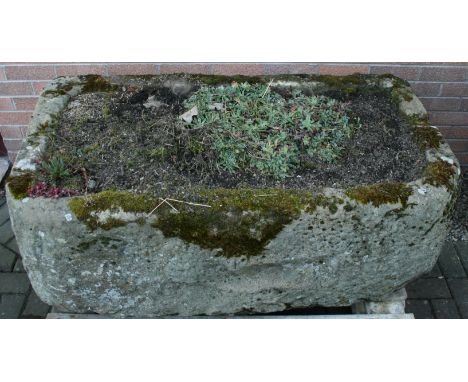 A LARGE LIMESTONE TROUGH of rectangular form with rounded front corners. 49cm(h) x 130cm(w) x 74cm(d) CONDITION: Some weather