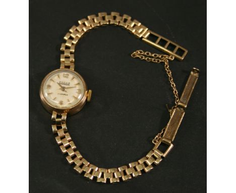 A LADIES 9CT GOLD BAUME WRISTWATCH with Arabic and baton markers, the gate type bracelet with safety clasp, marked 375, the c