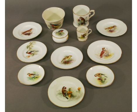 A COLLECTION OF ROYAL WORCESTER ORNITHOLOGICAL WARES eight small plates, two cups, a sugar bowl and lidded box, all decorated