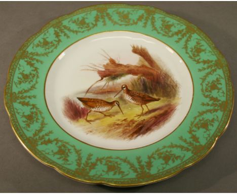 A ROYAL WORCESTER HAND DECORATED PLATE the interior painted with snipes within a green gilt decorated border, signed Johnston