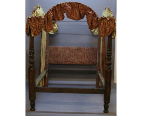 A MAHOGANY FOUR POSTER BED having material covered square section supports united by a material covered headboard, all linked