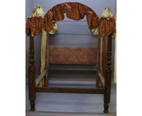 A MAHOGANY FOUR POSTER BED having material covered square section supports united by a material covered headboard, all linked