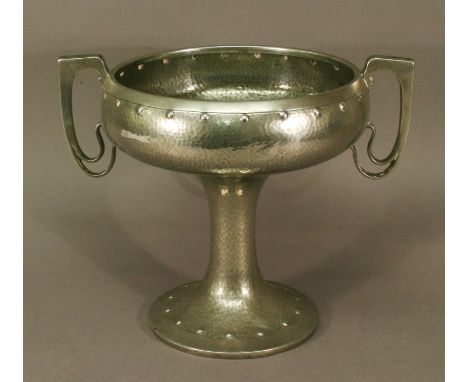 AN ARTS AND CRAFTS PEWTER PEDESTAL TWO-HANDLED BOWL with planished surface and punched roundel decoration, marked 'AM & CO M 
