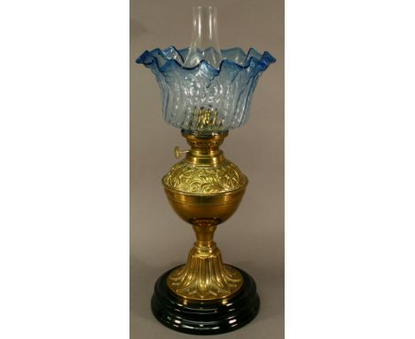 A FRENCH BRASS OIL LAMP with embossed foliate designs and blue tinted shade, the adjusters marked 'Gaudard made in France'. 3
