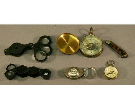 A GROUP OF THREE JEWELLERY LOUPES one with compass to the body, together with two pocket compasses and a pocket knife. (6) CO
