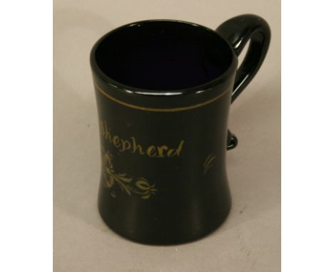 A 19TH CENTURY AMETHYST GLASS TANKARD with applied scroll handle, gilt decoration and name 'Jane Shepherd', kicked pontil. 9.