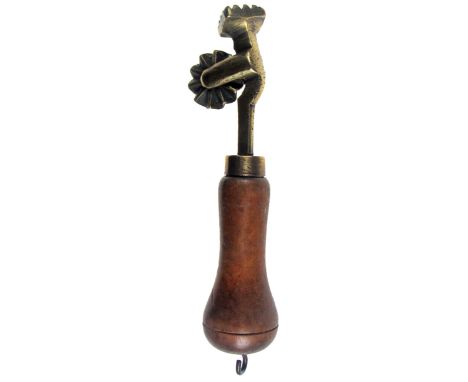 A 19TH CENTURY BRASS-HEADED PASTRY JIGGER with wheel and lozenge-shaped print, on a turned fruitwood handle, 14cm(L) CONDITIO