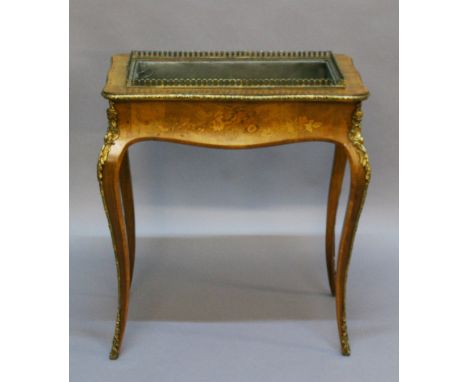 A VICTORIAN INLAID WALNUT PLANTER of subtle serpentine rectangular form with gilt metal moulded rim, crossbanded edge, short 