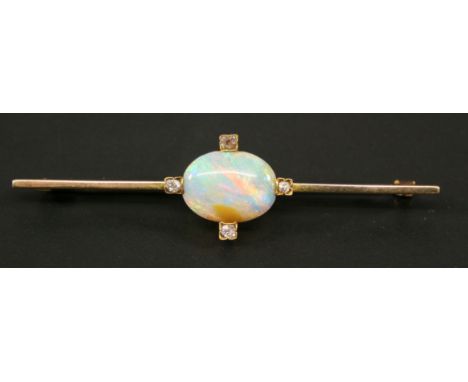 A YELLOW METAL OPAL AND DIAMOND BAR BROOCH, the slender bar set with a large central oval opal cabochon and four small diamon