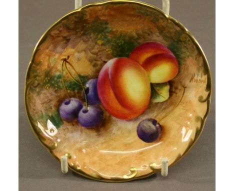 A ROYAL WORCESTER HAND-DECORATED PIN DISH of shaped circular form, decorated with fruit against a mossy setting, signed Rober