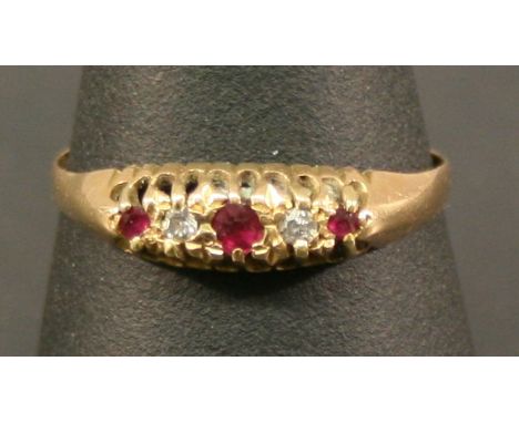 A YELLOW METAL RUBY AND DIAMOND RING with a linear arrangement of small stones, unmarked, testing as gold, ring size T. 2gram