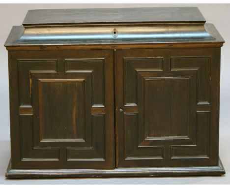 A 19TH CENTURY COLONIAL HARDWOOD TABLE CABINET having a hinged sarcophagus top opening to reveal an internal mirror and mater