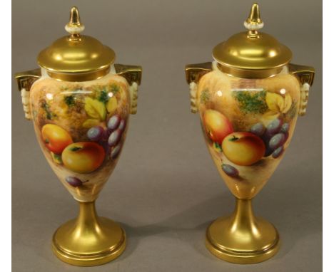 A PAIR OF ROYAL WORCESTER HAND-DECORATED URN-FORM VASES each having domed circular finial topped covers, ovoid body with Gree