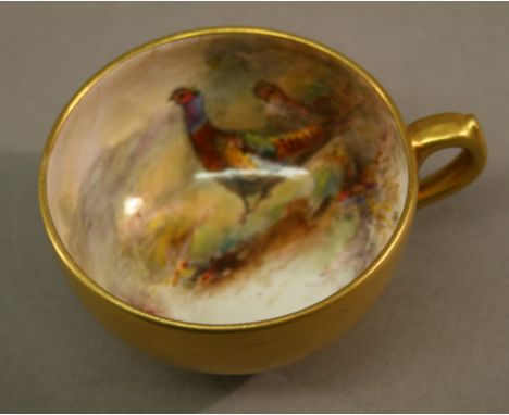 A ROYAL WORCESTER HAND-PAINTED CABINET CUP painted with pheasants, signed Stinton, gilt exterior, date code for 1925. CONDITI