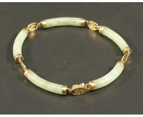 A 14K GOLD AND JADE BRACELET with five curved tubular jade links interspersed with gold Chinese characters, marked 14k. 19cm(