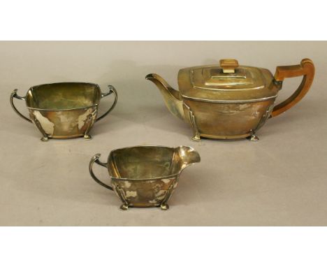 AN ART DECO SILVER THREE-PIECE TEASET of rounded rectangular form with stylised corner mouldings, Sheffield 1937, maker Harri