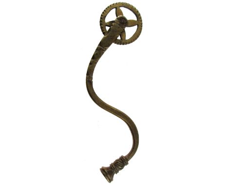 A 19TH CENTURY CAST BRASS PASTRY JIGGER with four-spoked wheel, curved handle with shaped decoration, the terminal having mat