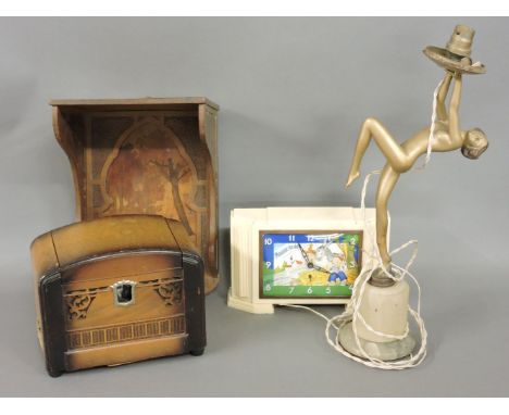 A French 1950s bakelite clock, with a coloured dial, a musical cigarette box, and a painted lamp base on an alabaster plinth