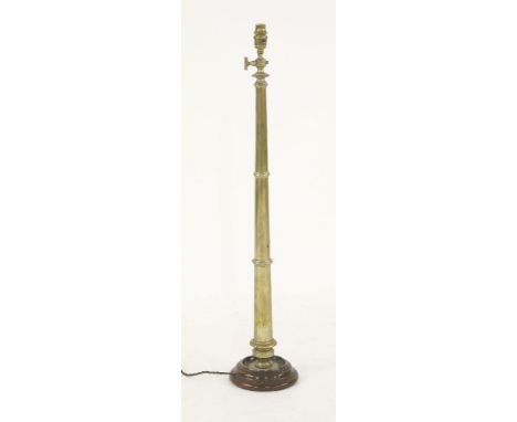 A tall turned brass table lamp, the tapering column on a turned wooden base, 84cm high