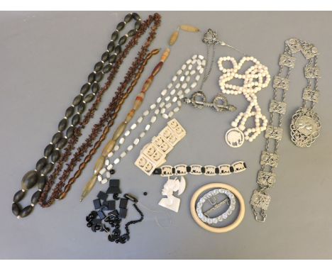 A graduated bone bead necklace, with a carved ivory pendant, an ivory bangle, two ivory bracelets and a brooch, an agate bead