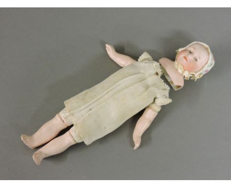 A German bisque head doll, with a moulded head and a bonnet, 822 Germany, 7cm