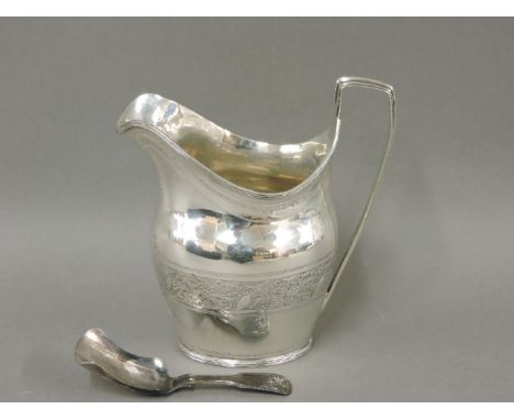 A Georgian silver cream jug, maker's mark GB, London 1798, with reeded handle and borders, bright cut engraved and monogramme