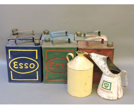 Six old petrol cans, with brass caps, BP, Dratts, and two jugs