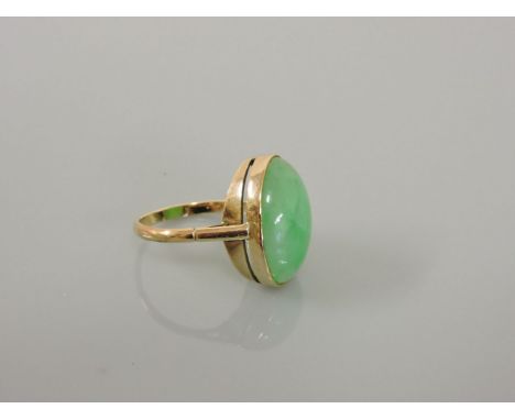 A gold single stone jade ring, 19.4 x 14.1mm, rub set to a plain yellow collet, tested as approximately 9ct gold, 6.38g, fing